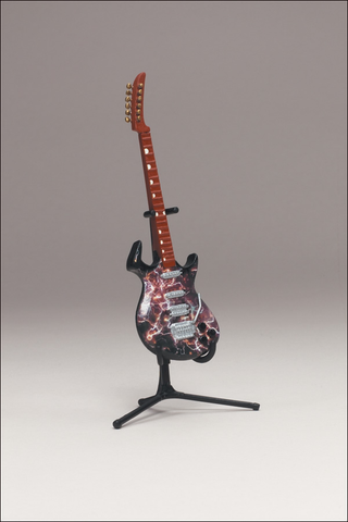 Illustration for article titled McFarlane's Tiny, Plastic Guitar Hero Guitars